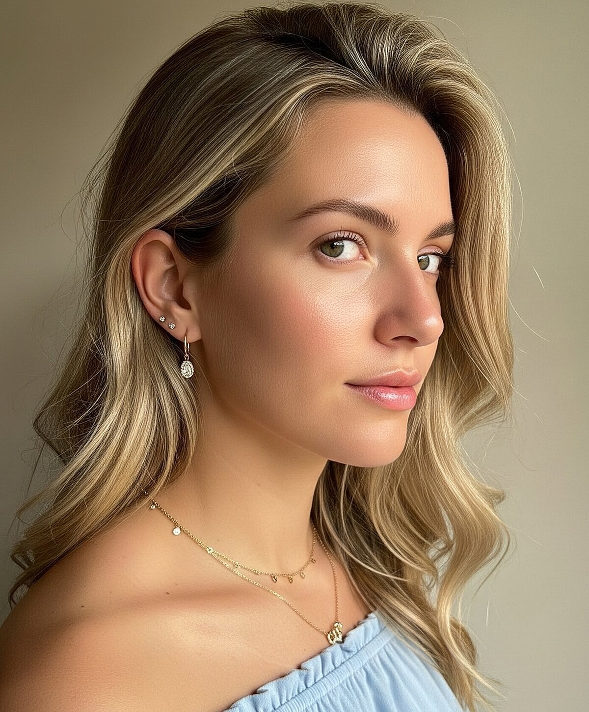 Woman with wavy hair and elegant jewelry.