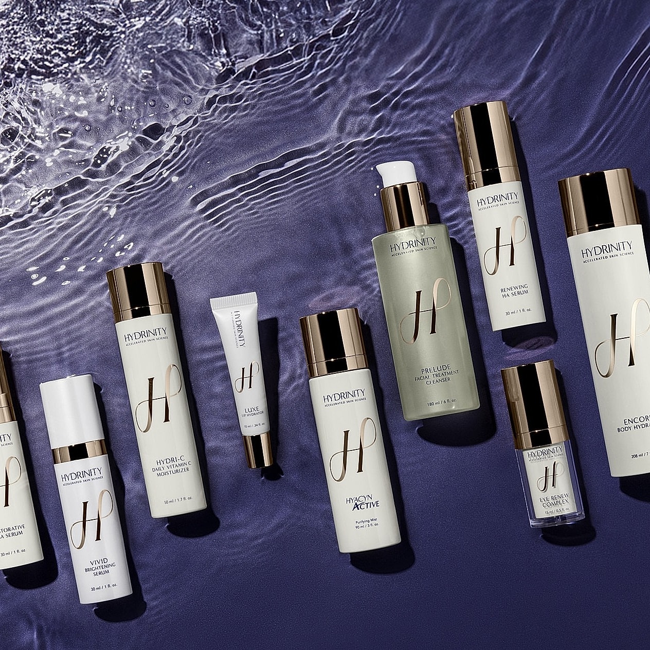 Assortment of skincare products arranged on water.