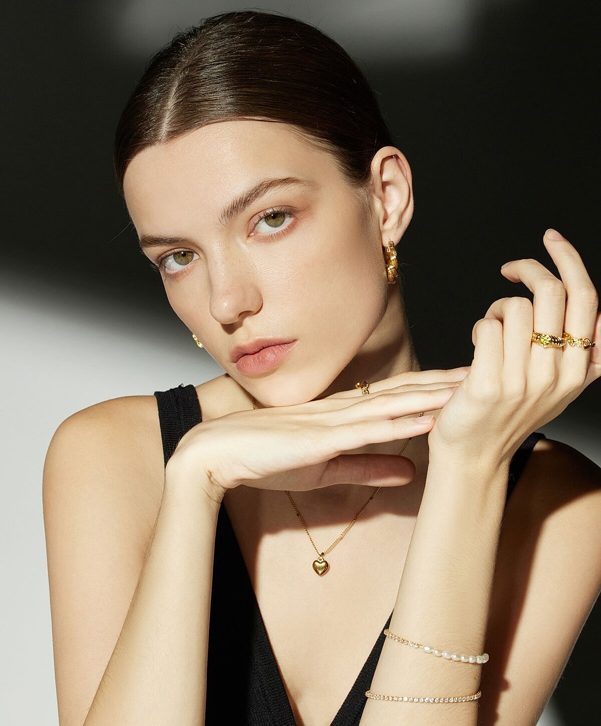 Portrait of a woman with natural makeup and jewelry.