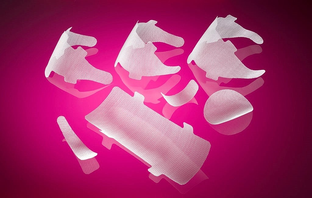 Medical adhesive bandages on a pink background.