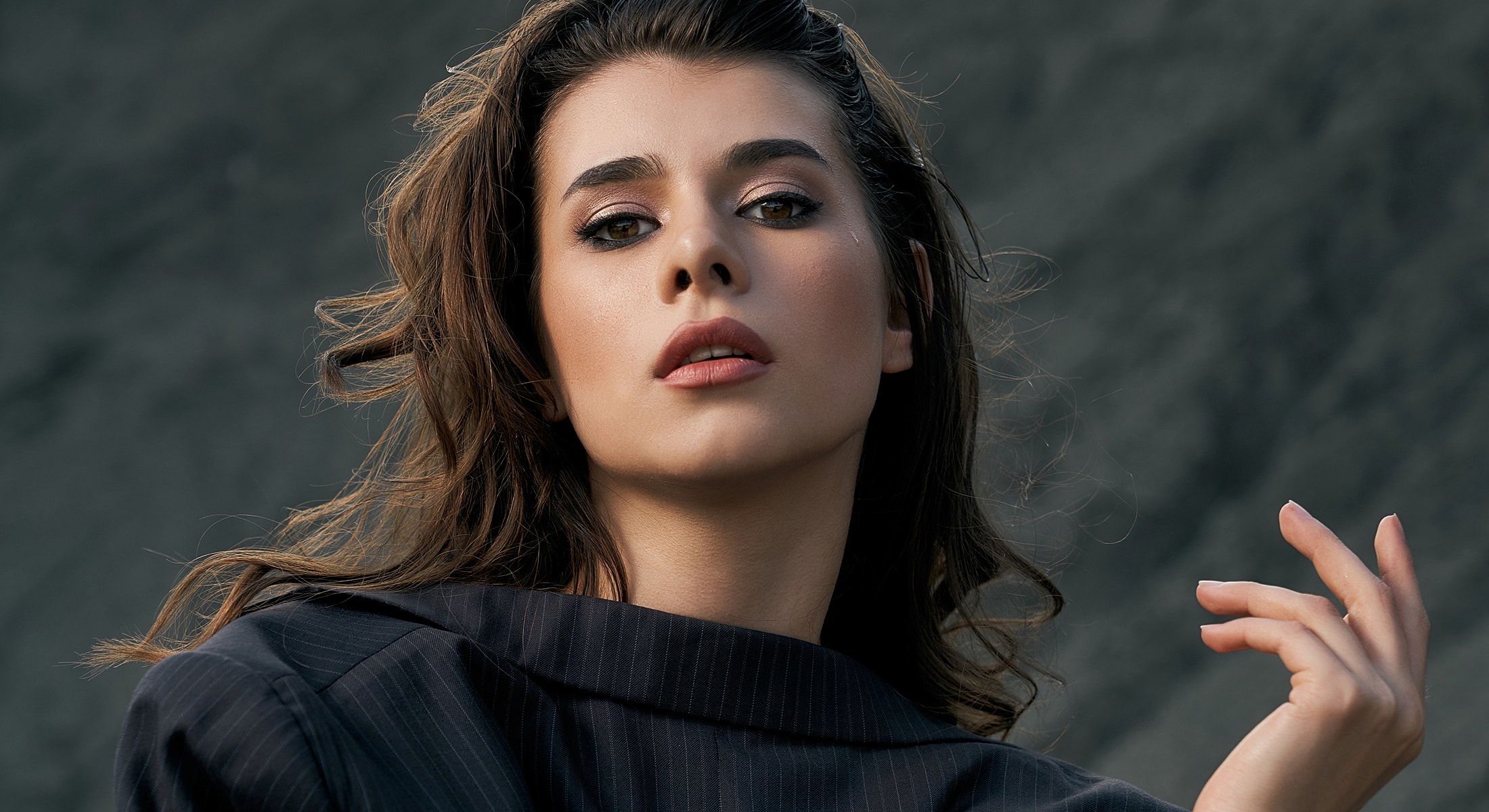 Woman posing with confident expression outdoors.